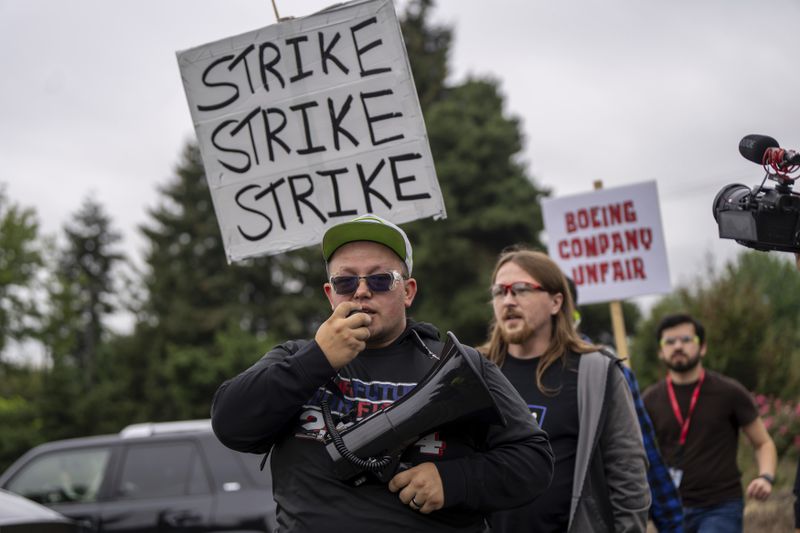 International Aerospace Machinists union members march toward the union's hall to vote on a contract offer with airplane maker Boeing, on Thursday, Sept. 12, 2024, in Renton, Wash. (AP Photo/Stephen Brashear)