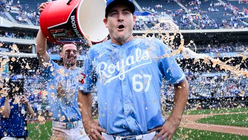Kansas City Royals starting pitcher Seth Lugo (67) is doused with ice water by Bobby Witt Jr. after pitching a complete game in their win over the Chicago White Sox during a baseball game, Sunday, July 21, 2024, in Kansas City, Mo. (AP Photo/Reed Hoffmann)