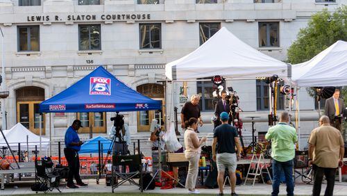 Television news crews line up outside the Fulton County Courthouse on Tuesday in the aftermath of a sweeping criminal indictment that brought charges against former President Donald Trump and 18 others.