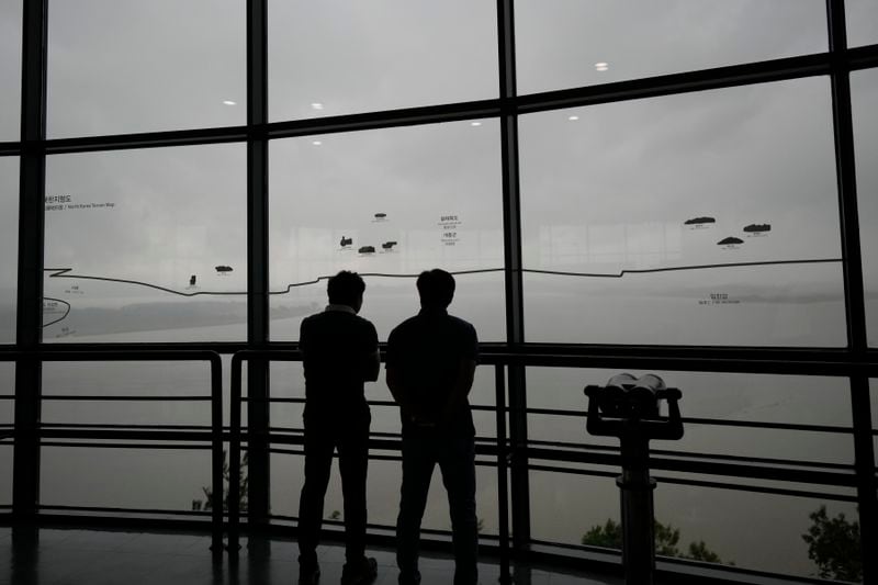 Visitors look at the North Korean side from the unification observatory in Paju, South Korea, Thursday, Sept. 5, 2024. (AP Photo/Lee Jin-man)