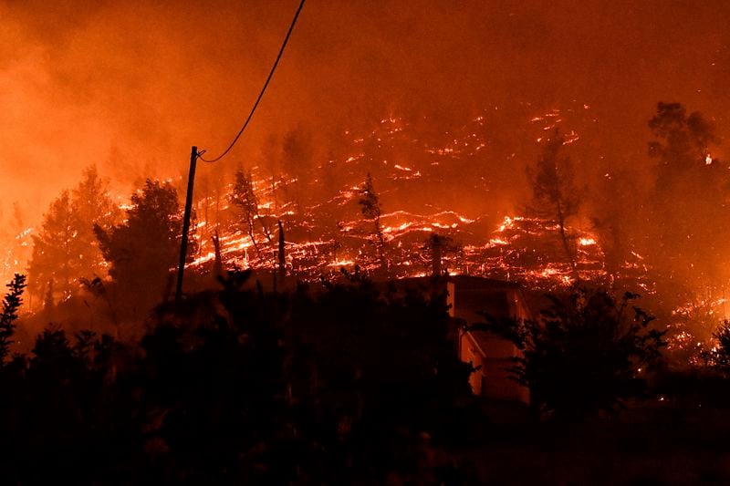 A wildfire burns a forest near the village of Kallithea as fanned by strong winds raged uncontrolled despite the attempts of hundreds of firefighters to stop it, some 149 kilometers (93 miles) west of Athens, Greece, in the region of Corinthia, late Sunday, Sept. 29, 2024. (AP Photo)