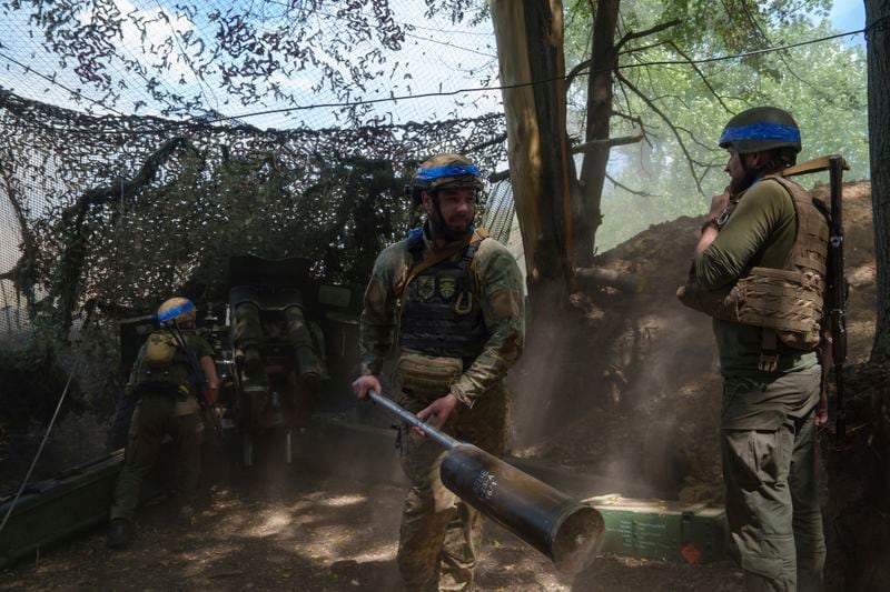 Ukrainian national guard servicemen of Khartia brigade reload a D-20 cannon while firing towards Russian positions on the front line near Kharkiv, Ukraine, Monday, June 10, 2024. (AP Photo/Evgeniy Maloletka)