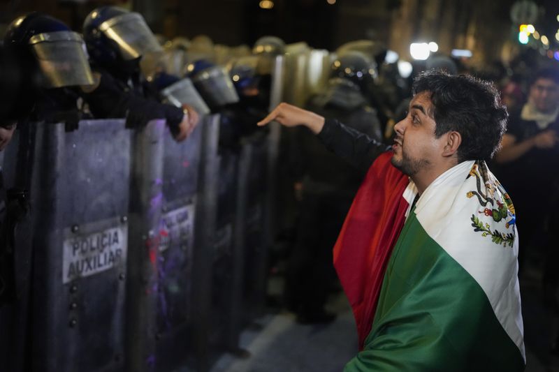 Judicial workers argue with the police during a protest the government's proposed judicial reform, which would make judges stand for election, outside the Senate in Mexico City, Tuesday, Sept. 10, 2024. (AP Photo/Eduardo Verdugo)