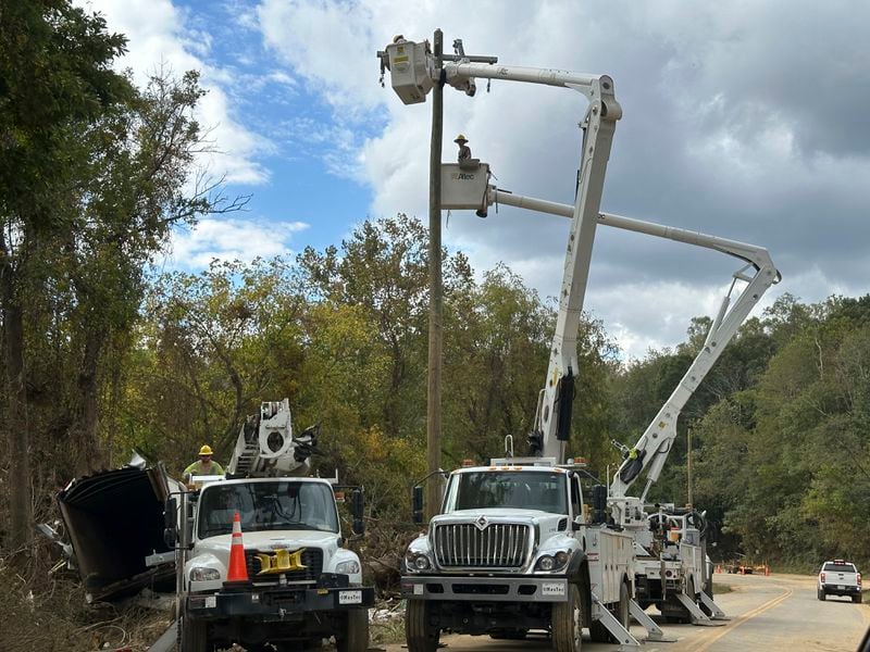 Contractors for Duke Energy rebuild destroyed electrical lines near the Swannanoa River in Asheville, N.C., Friday, Oct. 4, 2024. (AP Photo/Jeff Amy)