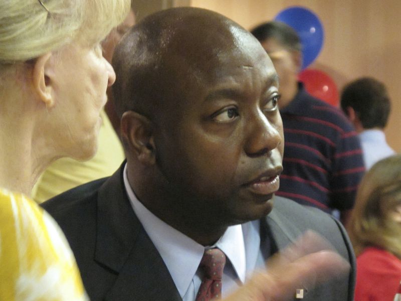FILE - South Carolina state Rep. Tim Scott, one of nine Republicans running for the GOP nomination in the state's 1st Congressional District, talks with a supporter, June 8, 2010, in North Charleston, S.C. Scott's life has been a series of people offering a hand that helped him get ahead. Now the senator from South Carolina waits to see if former President Donald Trump gives him another boost and makes him the vice presidential nominee. (AP Photo/Bruce Smith, File)