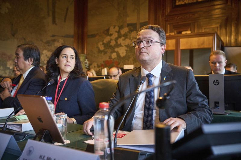 The Ukrainian delegation at the start of PCA Case between Ukraine and the Russian Federation in the Netherlands, Monday, Sept. 23, 2024. (AP Photo/Phil Nijhuis)