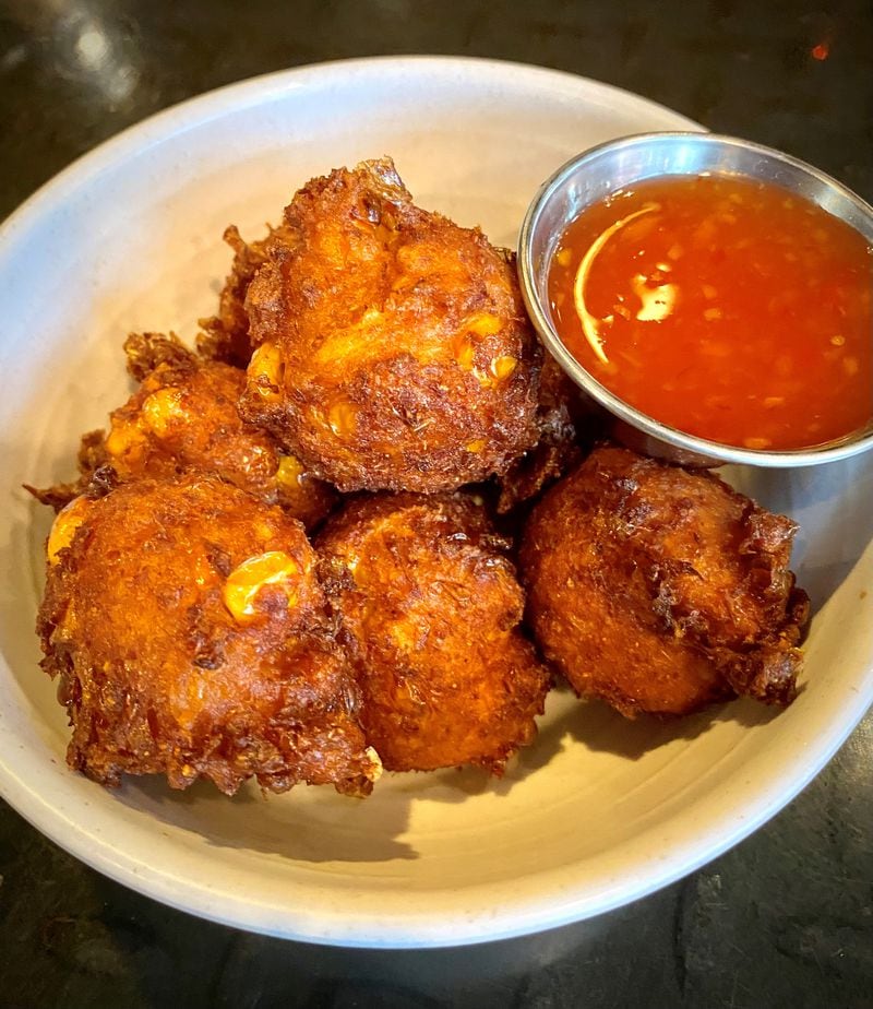 Jackalope’s corn fritters, made with red curry and lime leaf, and served with a sweet-chile dipping sauce, are one of the pop-up's more popular items. Wendell Brock for The Atlanta Journal-Constitution