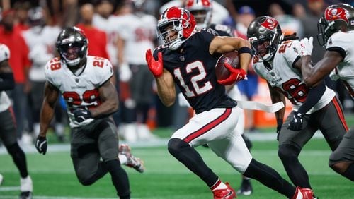 Atlanta Falcons wide receiver KhaDarel Hodge (12) is chased after breaking away during overtime of an NFL football game against the Tampa Bay Buccaneers on Thursday, October 3, 2024, at Mercedes-Benz Stadium in Atlanta. 
(Miguel Martinez/ AJC)