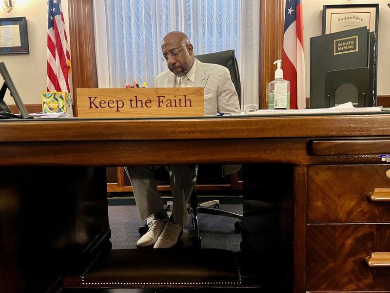 U.S. Sen. Raphael Warnock, who's also a senior pastor, works in his Washington office. The Atlanta Democrat delivered the opening prayer in the Senate chambers on Tuesday.