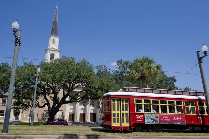 Equipped with solar panels and Tesla batteries, First Grace United Methodist Church, visible background left, is part of the Community Lighthouse initiative that uses microgrids, a small-scale power system that can operate and provide electricity amid hurricanes, in New Orleans, Wednesday, Sept. 25, 2024. (AP Photo/Matthew Hinton)