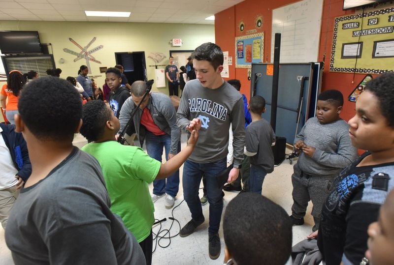 Aidan Anderson greets children after he shared his story at Samuel L. Jones Boys & Girls Club in Decatur. He also performed songs, including “Stand by Me” and Justin Bieber’s “Love Yourself.” HYOSUB SHIN / HSHIN@AJC.COM