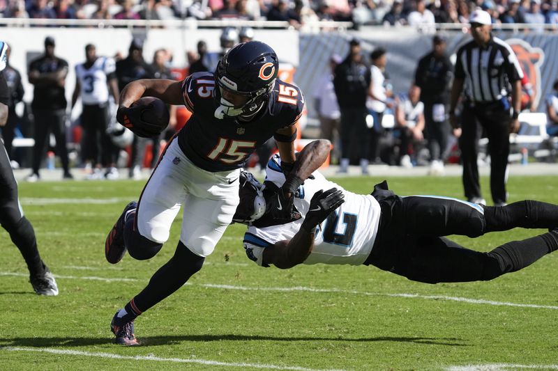 Chicago Bears wide receiver Rome Odunze (15) sheds the tackle of Carolina Panthers cornerback Michael Jackson (2) during the second half of an NFL football game Sunday, Oct. 6, 2024, in Chicago. (AP Photo/Nam Y. Huh)