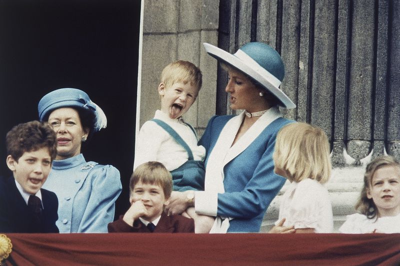 FILE - Britain's Prince Harry sticks out his tongue for the cameras on the balcony of Buckingham Palace in London, England on June 11, 1988, following the Trooping of the Colour. (AP Photo/Steve Holland, File)