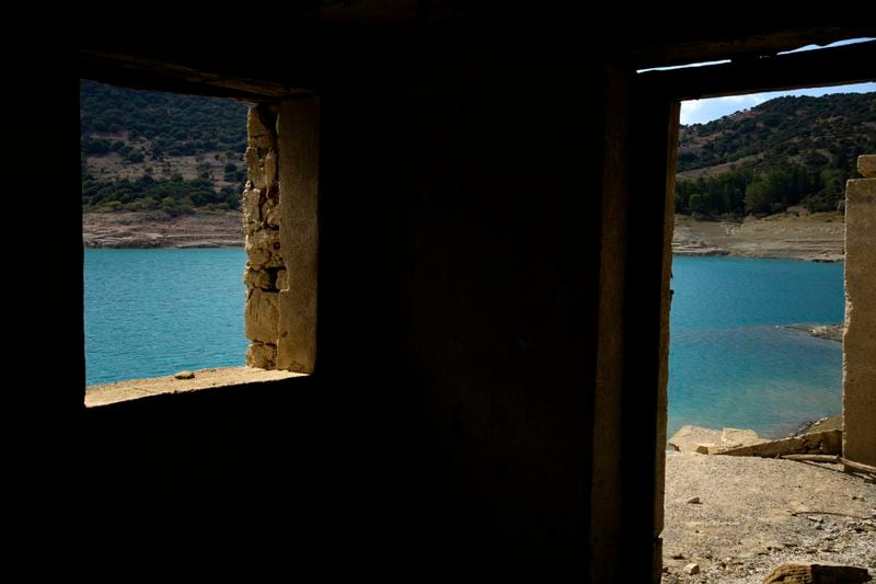 The window and the door of a building are seen in the sunken Kallio village that's resurfaced from the artificial Mornos Lake, the biggest of the four reservoirs supplying drinking water to Greece's capital which is at its lowest level in 16 years, some 200 kilometers (125 miles) northwest from Athens, central Greece, on Thursday, Sept. 5, 2024. (AP Photo/Thanassis Stavrakis)