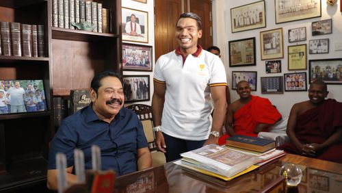 FILE -Sri Lankan Prime Minister Mahinda Rajapaksa sits for photographs, with his lawmaker son Namal by his side, following his election victory in the general election at his residence in Tangalle, Sri Lanka, Aug. 7, 2020. T (AP Photo/Eranga Jayawardena, File)