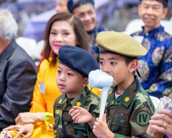 Enjoying the show, Thien-an Pham, with cotton candy, and Aiden Nguyen, both 7, have great seats for the lion dance on Saturday, Feb 3, 2024.  The Vietnamese American Community of Georgia hosts a Lunar New Year celebration at Plaza Las Americas in Lilburn on Saturday, Feb 3, 2024 where dragon and lion dancing begins the weekend.  The celebration continues on Sunday and includes traditional food, music and cultural festivities.  (Jenni Girtman for The Atlanta Journal-Constitution)