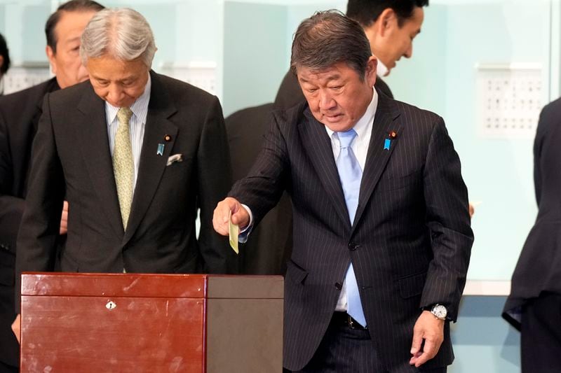 One of candidates, Toshimitsu Motegi, right, casts his ballot at the ruling Liberal Democratic Party's (LDP) leadership election Friday, Sept. 27, 2024, in Tokyo. (AP Photo/Hiro Komae, Pool)