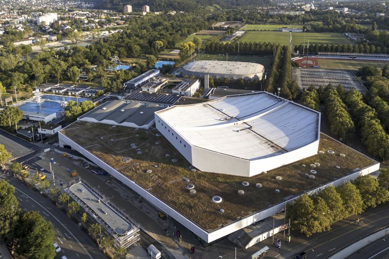 The St. Jakobshalle arena, front, which is the venue for the Eurovision Song Contest 2025 is seen, in Basel, Wednesday Aug. 28, 2024. (Georgios Kefalas/Keystone via AP)