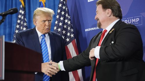 FILE - Nevada GOP chair Michael McDonald, right, shakes hands with Republican presidential candidate former President Donald Trump at a campaign event, Jan. 27, 2024, in Las Vegas. A Nevada state court judge dismissed a criminal indictment Friday, June 21, 2024, against six Republicans accused of submitting certificates to Congress falsely declaring Donald Trump the winner of the state’s 2020 presidential election. (AP Photo/John Locher, File)