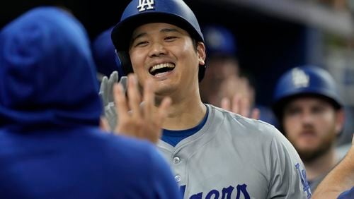 Los Angeles Dodgers' Shohei Ohtani (17) celebrates his 51 home run of the season during the ninth inning of a baseball game against the Miami Marlins, Thursday, Sept. 19, 2024, in Miami. (AP Photo/Marta Lavandier)