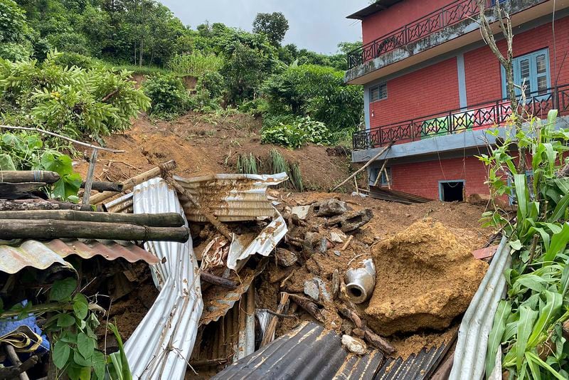 Damaged houses knocked by landslides are seen on the outskirts Pokhara, Nepal, Friday, July 12, 2024. (AP Photo/Yunish Gurung)