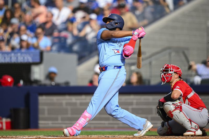 Toronto Blue Jays' Vladimir Guerrero Jr. hits a home run during the eighth inning of a baseball game against the Los Angeles Angels, in Toronto, Saturday, Aug. 24, 2024. (Christopher Katsarov/The Canadian Press via AP)