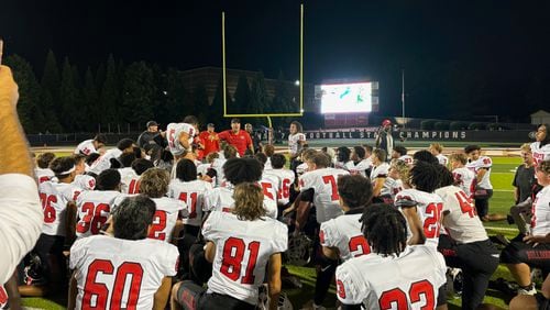 North Gwinnett coach Eric Godfree speaks to his team after their 37-34 win over Mill Creek on Sept. 6, 2024, in Hoschton.