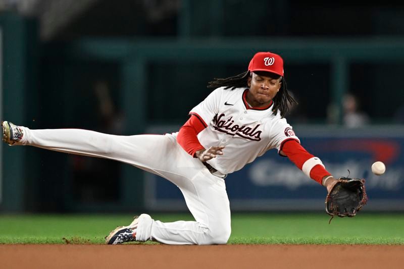 Washington Nationals shortstop CJ Abrams dives and misses Atlanta Braves Michael Harris II's single during the seventh inning of a baseball game, Tuesday, Sept. 10, 2024, in Washington. (AP Photo/John McDonnell)