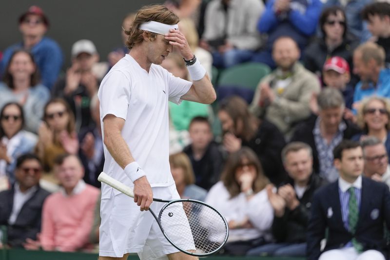 Andrey Rublev of Russia reacts during his first round loss to Francisco Comesana of Argentina at the Wimbledon tennis championships in London, Tuesday, July 2, 2024. (AP Photo/Alberto Pezzali)
