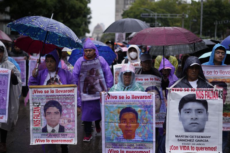 Families and friends they take part in a demonstration marking the 10-year anniversary of the disappearance of 43 students from an Ayotzinapa rural teacher's college, in Mexico City, Thursday, Sept. 26, 2024. (AP Photo/Eduardo Verdugo)