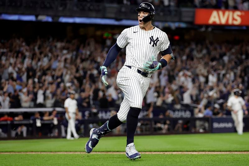 New York Yankees' Aaron Judge reacts after hitting a grand slam during the seventh inning of a baseball game at bat Friday, Sept. 13, 2024, in New York. (AP Photo/Adam Hunger)