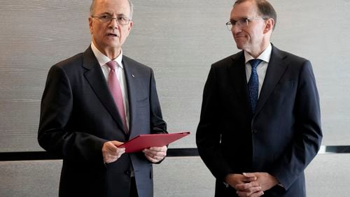 Prime Minister of the Palestinian Authority Mohammed Mustafa, left, speaks after receiving a document handed over by Norway's Foreign Minister Espen Barth Eide, right, prior to a meeting for talks on the Middle East in Brussels, Sunday, May 26, 2024. Norway on Sunday handed over papers to the Palestinian prime minister to officially give it diplomatic recognition as a state in a largely symbolic move that has infuriated Israel. The formal recognition by Norway, Spain and Ireland, which all have a record of friendly ties with both the Israelis and the Palestinians, while long advocating for a Palestinian state, is planned for Tuesday. (AP Photo/Virginia Mayo)