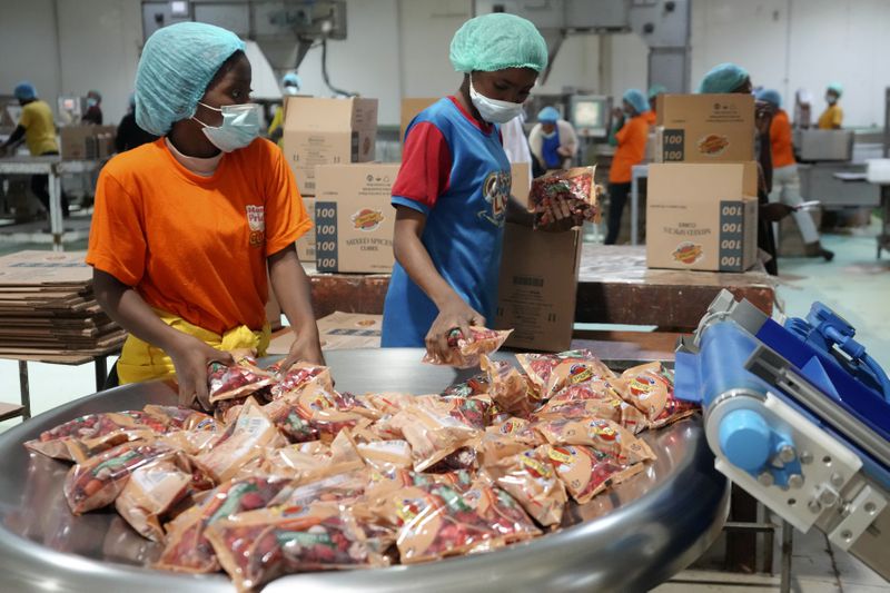 Workers collect bouillon cubes packages at the Sweet Nutrition factory in Otta, Nigeria, Thursday, Sept. 12, 2024. (AP Photo/Sunday Alamba)