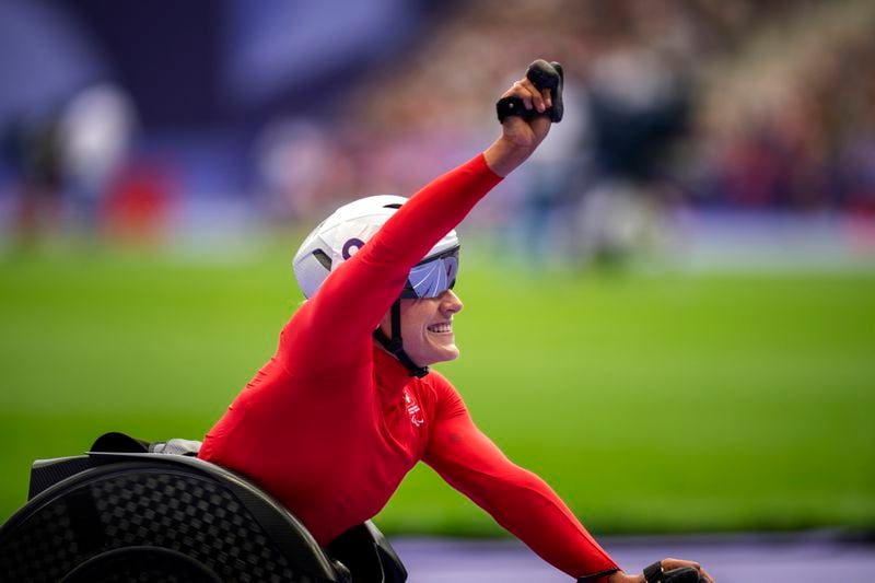 Catherine Debrunner, of Switzerland, celebrates after winning at Women's 5000m - T54 final at the Stade de France stadium, during the 2024 Paralympics, Saturday, Aug. 31, 2024, in Paris, France. (AP Photo/Emilio Morenatti)