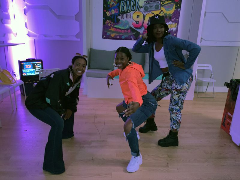 Three friends dressed in '90s style for the "Save the Video Store" experience (from left): Maegann Stafford, 25, of Atlanta; Shay Blake, 32, of Peachtree Corners; and Alexis Clark, 24, of Jonesboro. RODNEY HO/rho@ajc.com