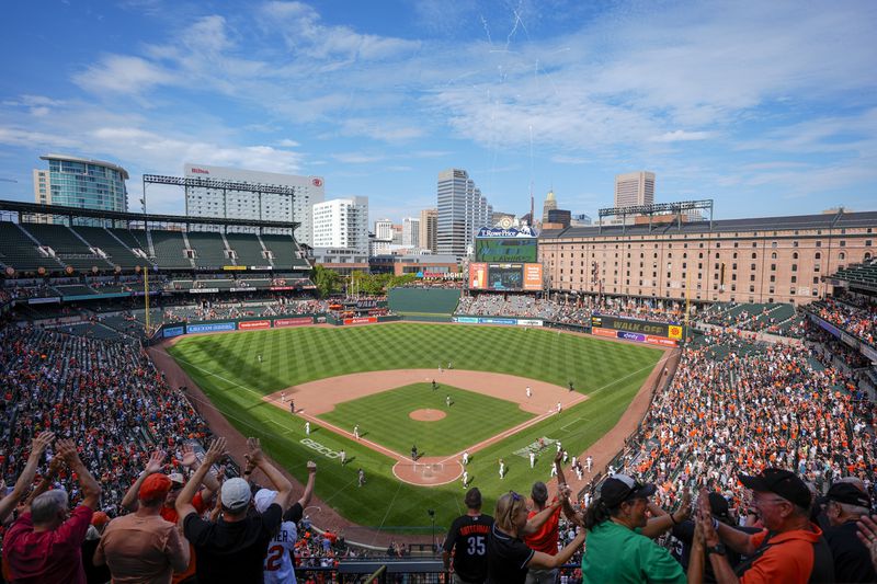 Fans celebrate after a Baltimore Orioles's walkoff win over the San Francisco Giants after a baseball game, Thursday, Sept. 19, 2024, in Baltimore. (AP Photo/Stephanie Scarbrough)