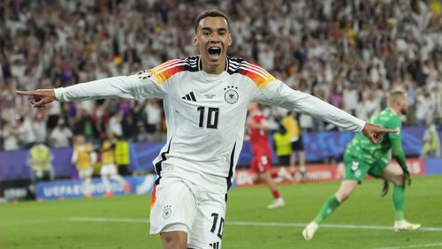 Germany's Jamal Musiala celebrates after scoring his side's second goal during a round of sixteen match between Germany and Denmark at the Euro 2024 soccer tournament in Dortmund, Germany, Saturday, June 29, 2024. (AP Photo/Andreea Alexandru)