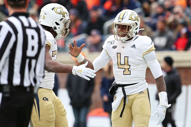 James Graham #4 and Jordan Mason #27 of the Georgia Tech Yellow Jackets celebrate a touchdown in the first half during a game against the Virginia Cavaliers at Scott Stadium on November 9, 2019 in Charlottesville, Virginia. (Photo by Ryan M. Kelly/Getty Images)