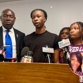 Malachi Hill Massey, 17, center, speaks at a news conference on Tuesday, July 23, 2024, at the NAACP headquarters in Springfield, Ill., about his mother, Sonya Massey, who was shot to death by a Sangamon County Sheriff's deputy on July 6 in Springfield after calling 911 for help. On the left is civil right attorney Ben Crump, who is representing the Massey family. On the right is Sonya Massey's daughter, Jeanette Summer Massey, 15. (AP Photo/John O'Connor)