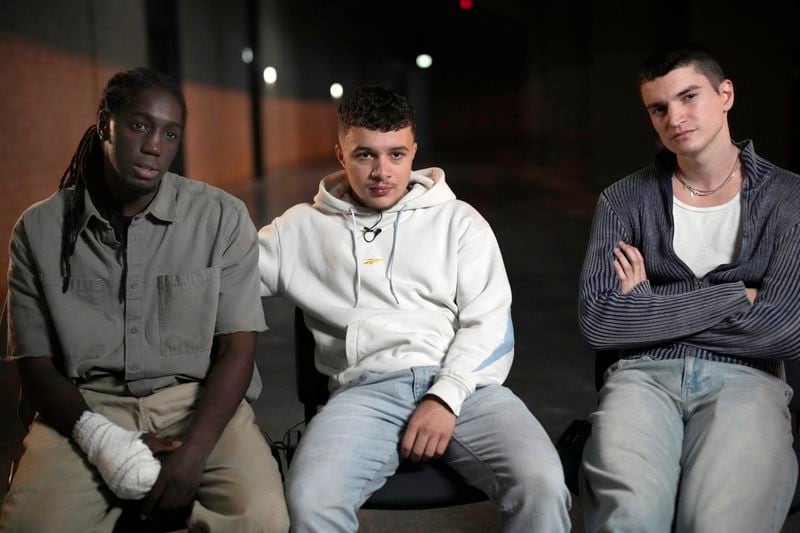 Actors Aliyou Diop, left, Samy Belkessa center, and Alexander Ferrario pose in Tremblay en France,Tuesday, Sept. 17, 2024. (AP Photo/Christophe Ena)