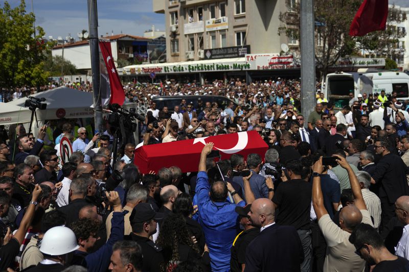 The coffin of Aysenur Ezgi Eygi, a 26 year-old Turkish-American activist killed by the Israeli military, is carried during her funeral in Didim, Turkey, Saturday, Sept. 14, 2024,(AP Photo/Khalil Hamra)