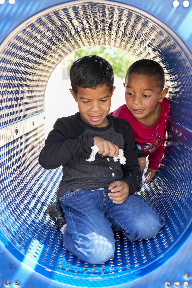 Manuel Rodriquez, left, and Dylan Guzman play in a park Friday, May 18, 2024, in Aurora, Colo. (AP Photo/Jack Dempsey)