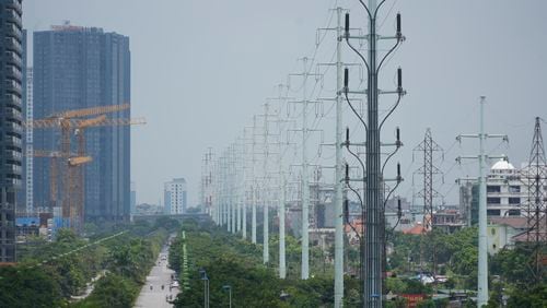 This photo shows power lines in Hanoi, Vietnam, Tuesday, July 9, 2024. Vietnam will let electricity-guzzling factories buy electricity from wind and solar power producers, helping big companies like Samsung Electronics meet their climate targets and relieving pressure on the country's overstrained grid. (AP Photo/Hau Dinh)