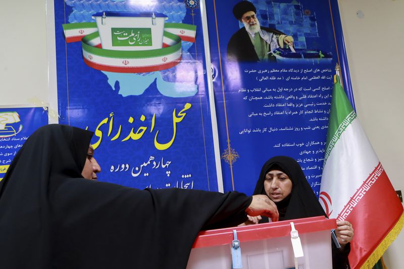 Iranian citizens cast their votes during the presidential election at the Iranian consulate in Basra southeast of Baghdad, Iraq, Friday, June 28, 2024. Iranians are voting in a presidential election to replace the late President Ebrahim Raisi, killed in a helicopter crash in May along with the country's foreign minister and several other officials. (AP Photo/Nabil al-Jourani)