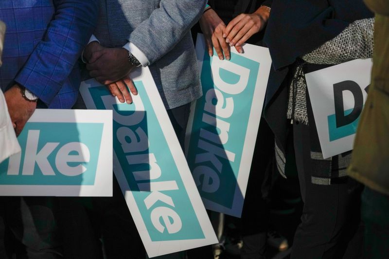 Supporters of the OVP, Austrian People's Party, hold "Thank You" banners at the party headquarters in Vienna, Austria, Sunday, Sept. 29, 2024, after seeing the first electoral projections in the country's national election. (AP Photo/Andreea Alexandru)