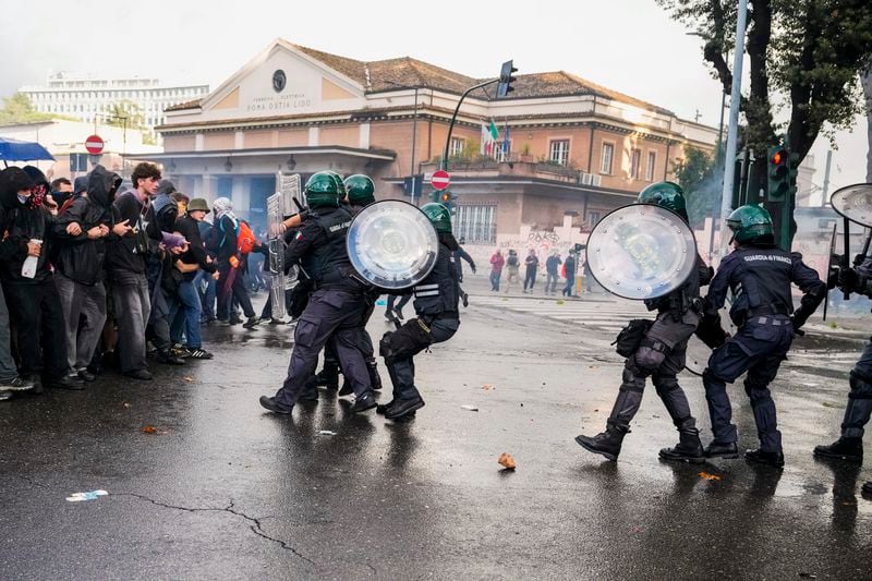 Italian Police and demonstrators clash during a march in support of the Palestinian people in Rome, Saturday, Oct. 5, 2024, two days before the anniversary of Hamas-led groups attack in Israeli territory outside of Gaza on Oct. 7, 2023. (AP Photo/Andrew Medichini)