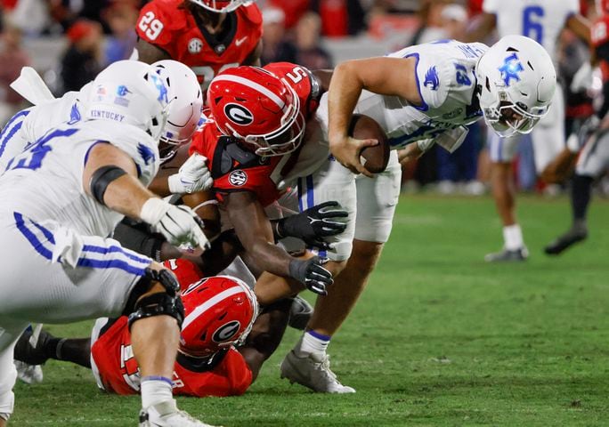 Georgia Bulldogs linebacker Raylen Wilson (5) and  linebacker Jalon Walker (11) sack  Kentucky Wildcats quarterback Devin Leary (13) for a loss during the second half of an NCAA football game between Kentucky and Georgia in Athens on Saturday, Oct. 7, 2023.  (Bob Andres for the Atlanta Journal Constitution)