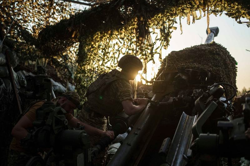 Ukrainian servicemen of 148th separate artillery brigade of the Air Assault Forces prepare their M777 howitzer before firing towards Russian positions at the frontline in Donetsk region, Ukraine, Wednesday, August 21, 2024. (AP Photo/Evgeniy Maloletka)