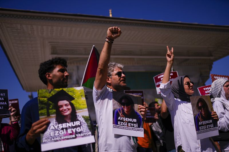 People hold photographs of Aysenur Ezgi Eygi, 26 year-old Turkish-American activist killed by the Israeli military, as they shout slogans during a protest in her memory in Istanbul, Turkey, Saturday, Sept. 14, 2024. (AP Photo/Francisco Seco)