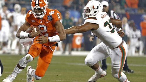 Clemson's Kelly Bryant (2) runs as Miami's Trent Harris (33) defends during the first half of the Atlantic Coast Conference championship NCAA college football game in Charlotte, N.C., Saturday, Dec. 2, 2017. (AP Photo/Bob Leverone)